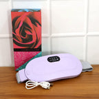 Woman comfortably using the Menstrual Cramp Relief Belt at home for relaxation.