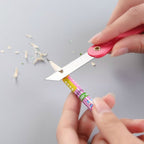Vibrant multicolour handle of a mini paper cutter knife showing ergonomic design.