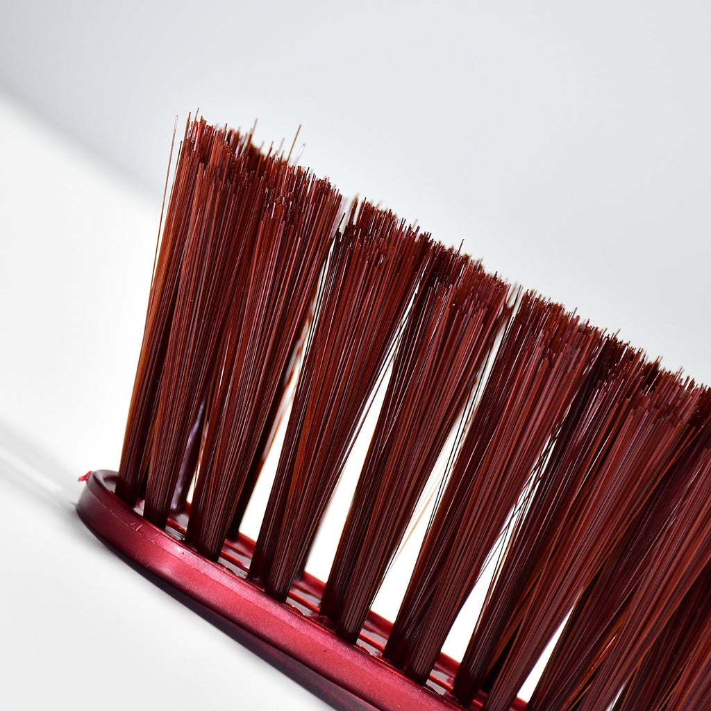 Velvet Wipe duster brush gently removing dust from a car dashboard.