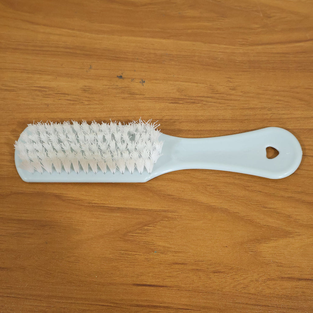 Close-up of ergonomic handle and bristles on handheld cleaning brush