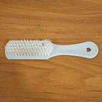 Close-up of ergonomic handle and bristles on handheld cleaning brush