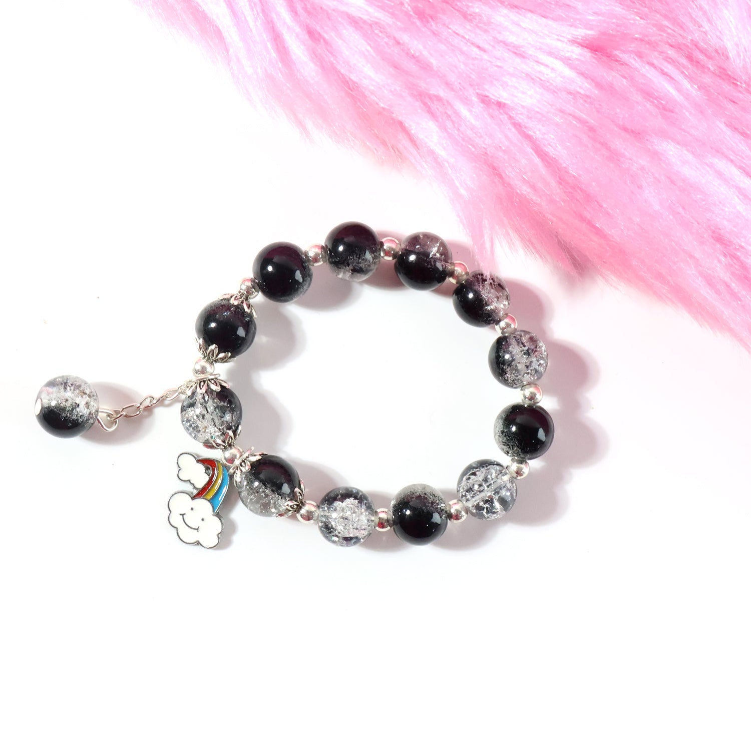 Side view of stretchable black and crystal beaded charm bracelet