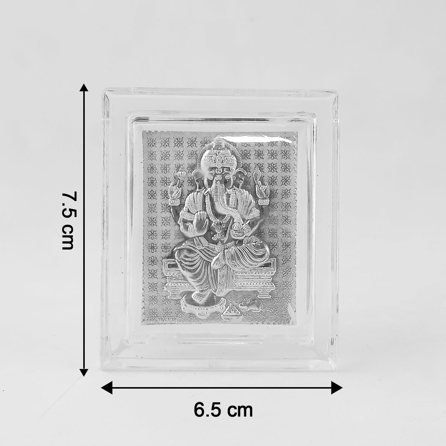 Sacred silver embossed Lord Ganesha photo frame displayed on altar