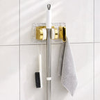 Space saving broom and mop hanger wall mounted with self adhesive base