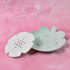 Close-up of the flower-shaped plastic soap dish, highlighting the detailed design.