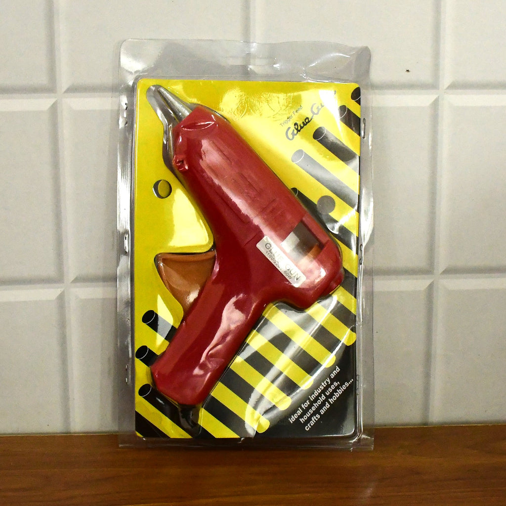 All components of the hot melt glue gun kit laid out.