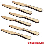 Top-down view of a single gold dinner knife and spoon.