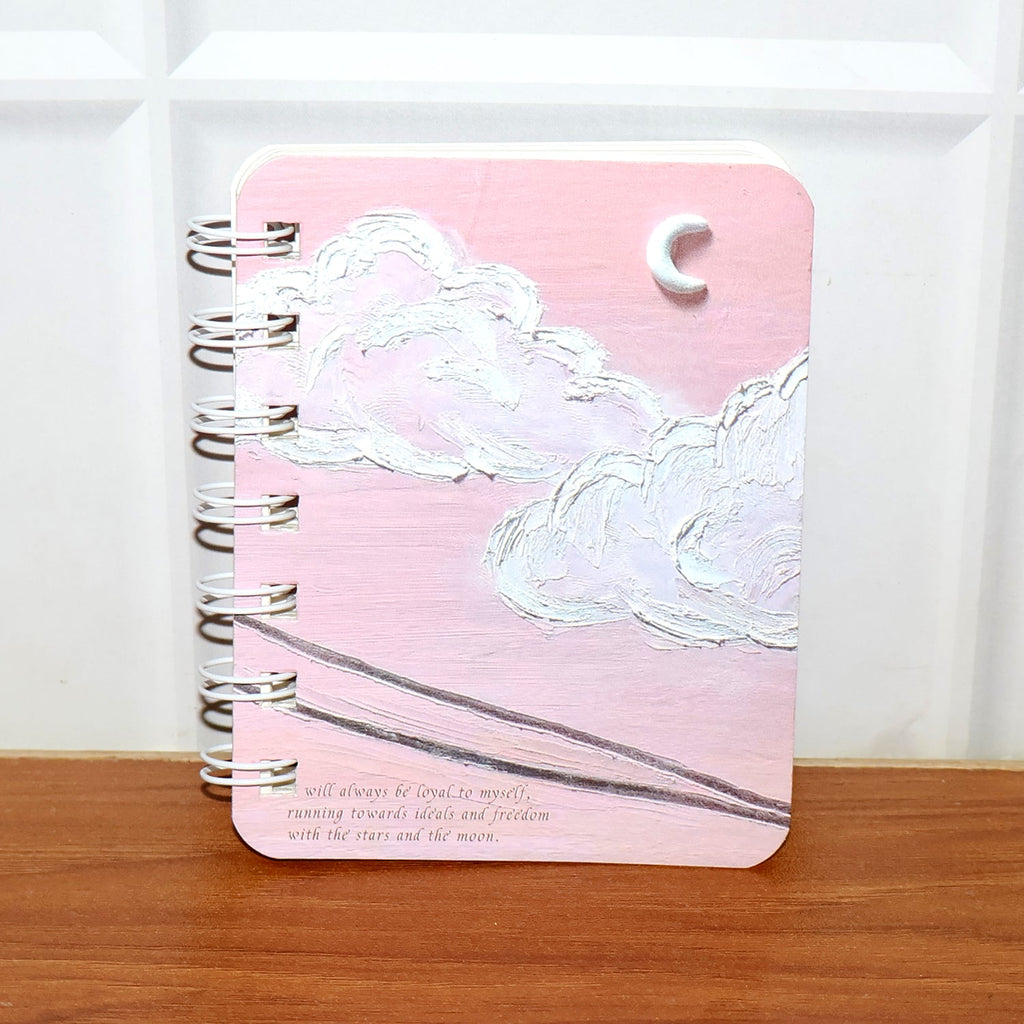 Spiral bound pocket notebook showing sturdy green wire-o binding