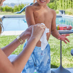 Close-up of a facial cleansing wipe with water droplets, emphasizing its hydrating properties.