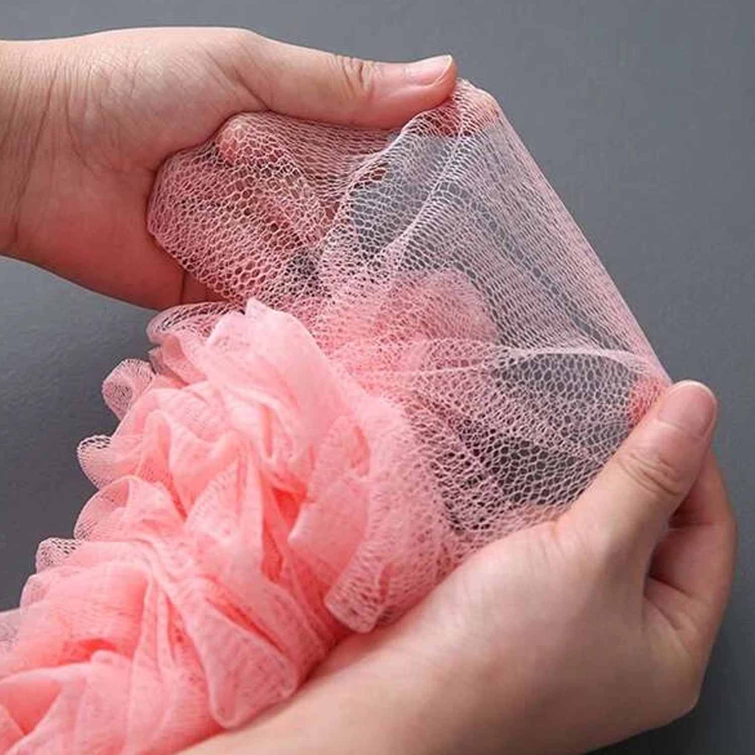 Soft nylon mesh bath brush creating rich foam for a luxurious bathing experience.