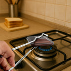 Close-up of heat-resistant handle on gas stove sandwich toaster for safe cooking
