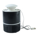 Unplugged mosquito trap device on table demonstrating compact design
