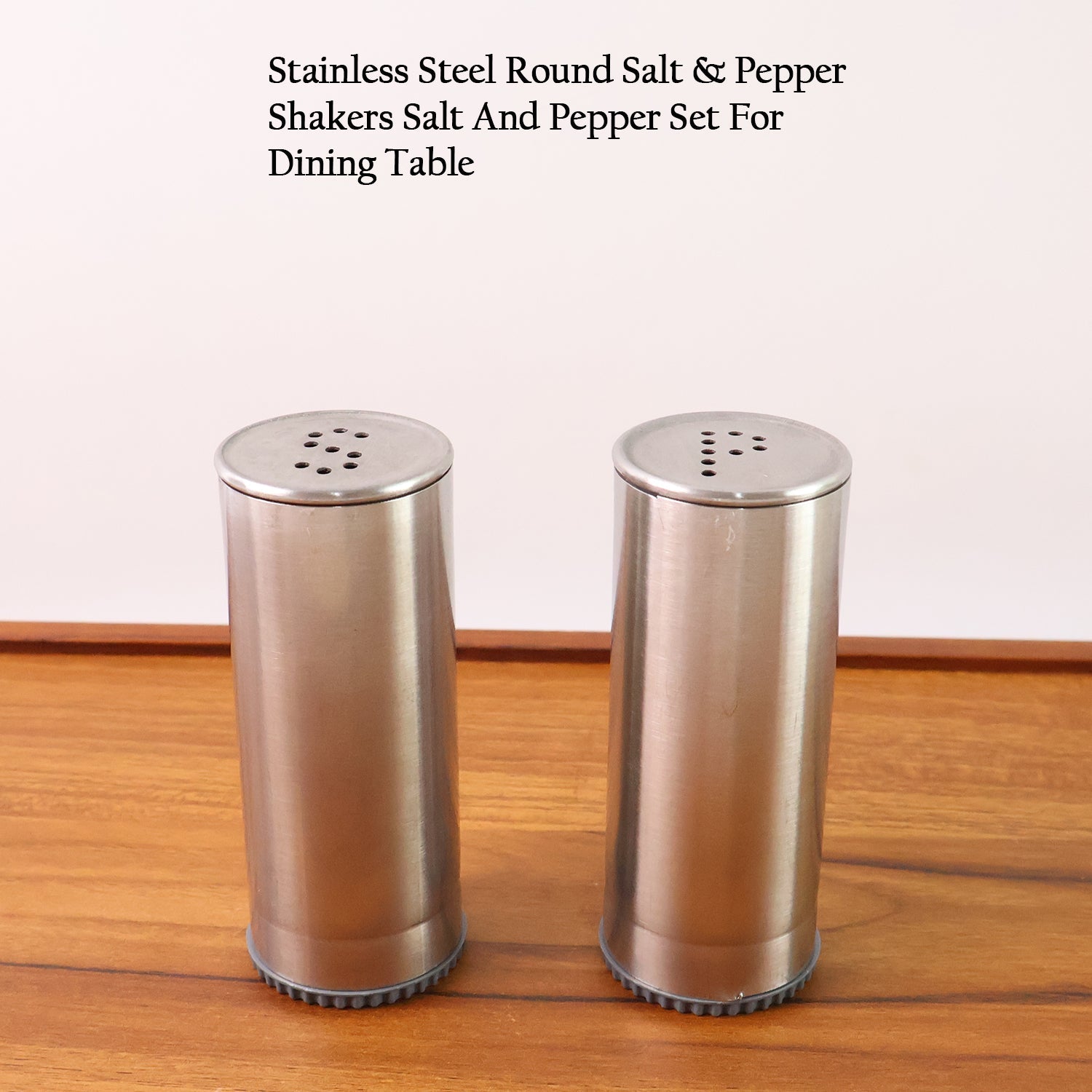 Sleek stainless steel salt and pepper dispensers with twist-off lids