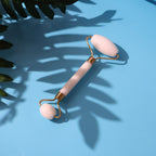 Smooth dual-head facial roller resting on a white surface, ready for use.