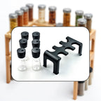 Plastic spice jars with clear bodies and rotating lids on organizer stand