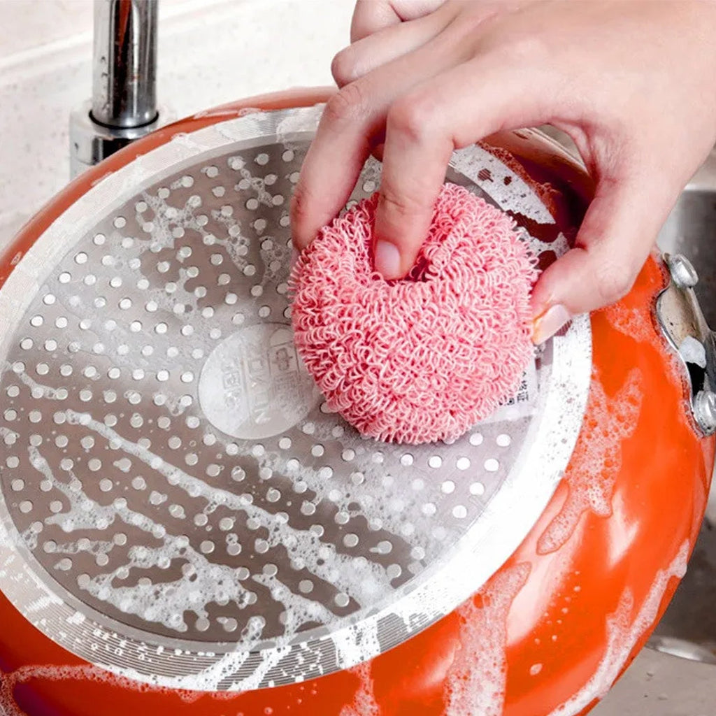 Scrub brush removing tough stains from kitchen surfaces