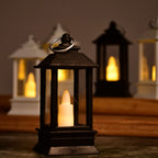 Elegant black decorative lantern with a safe artificial candle.