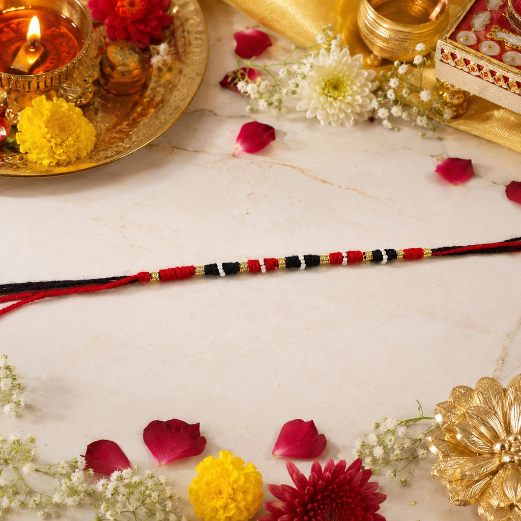 Close-up of traditional handmade red black thread rakhi with beads