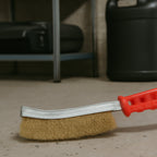 User holding the wire hand brush, preparing a metal surface.