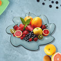 A vibrant orange flower shaped kids plastic plate displayed on a clean white surface.