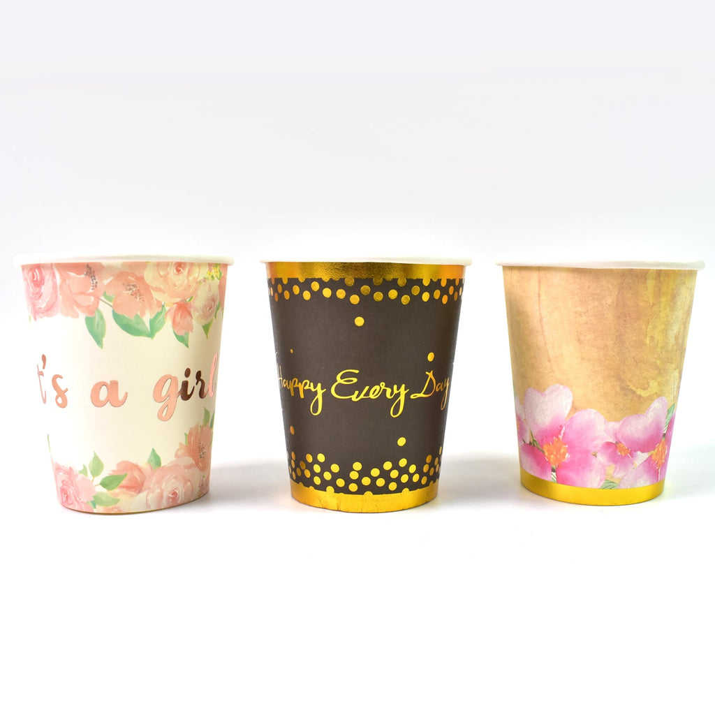 Set of disposable paper cups arranged neatly on a surface.