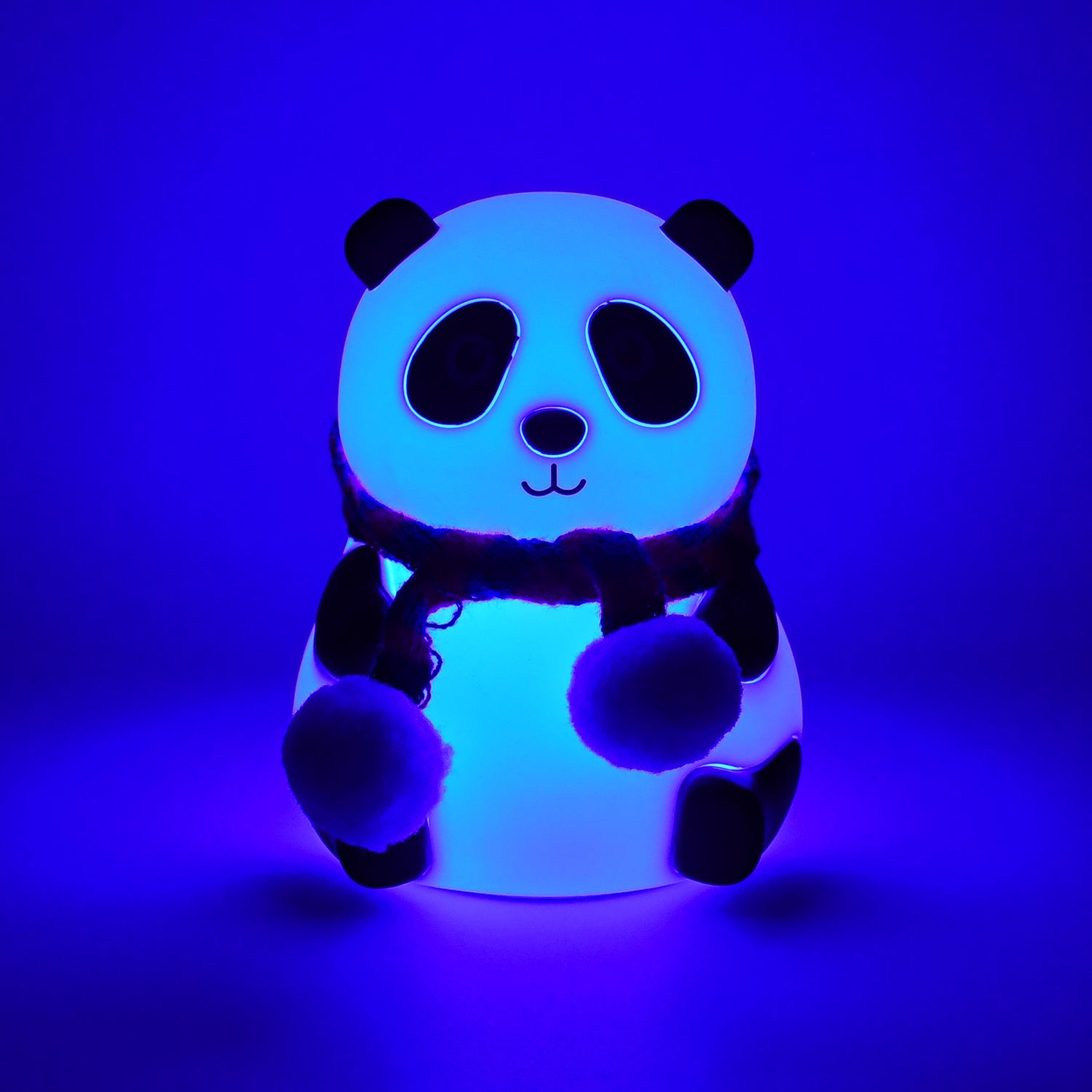 Panda night light illuminating a dark room with a warm, inviting yellow hue.