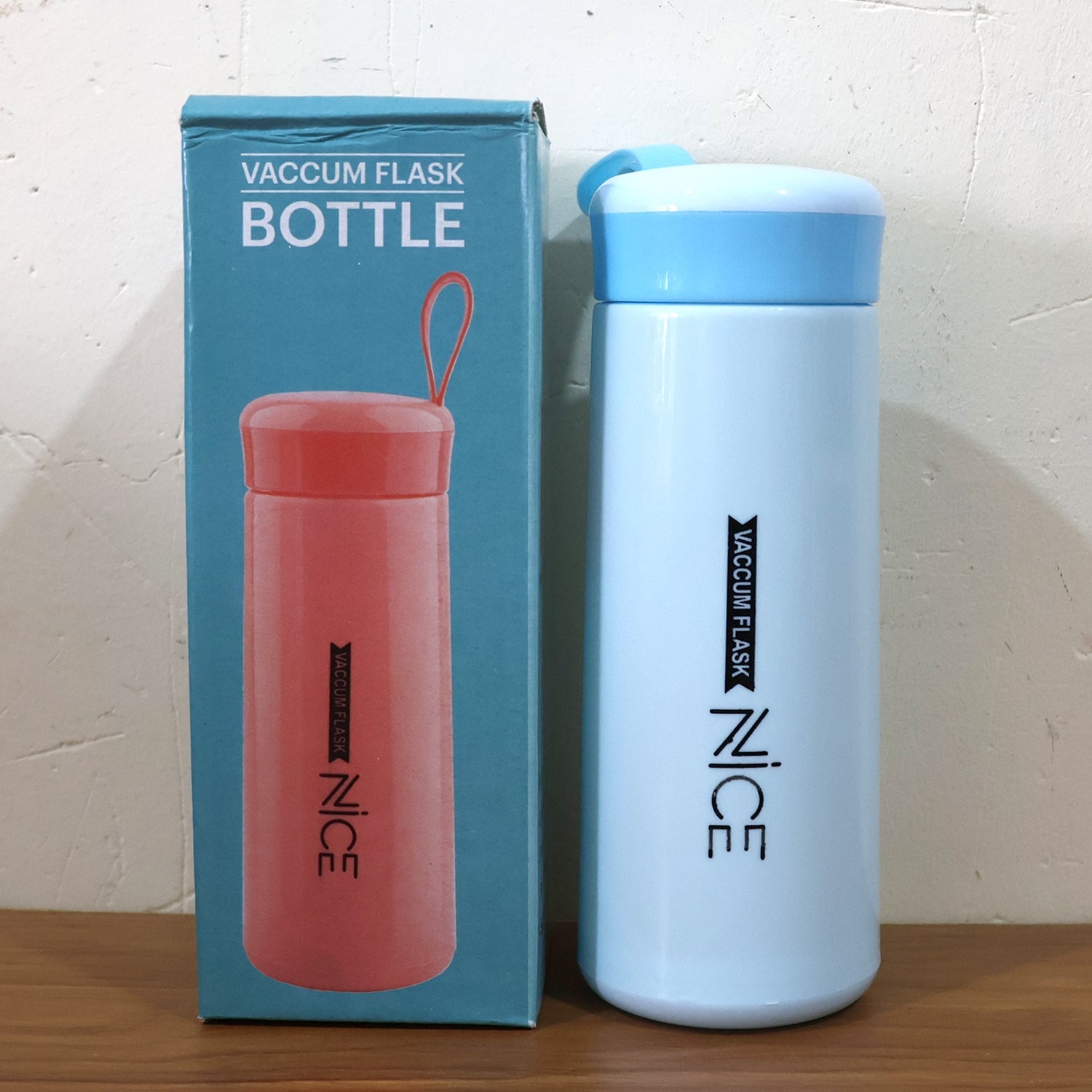 Compact plastic water bottle with blue lid and white body for travel