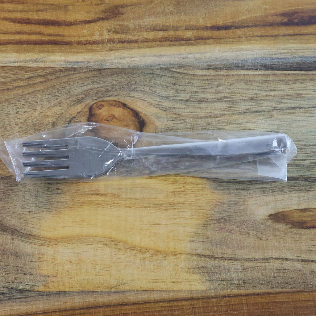 Shiny polished stainless steel dining forks, highlighting their sleek mirror finish.
