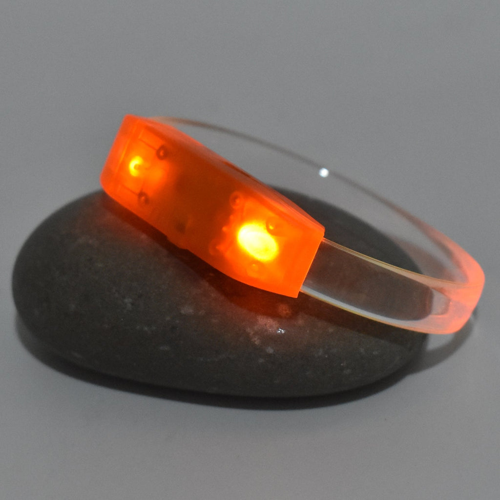 Colorful LED running bracelet highlighting its replaceable batteries for extended use.