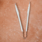 Cooking tongs featuring comfortable plastic handles for prolonged use.