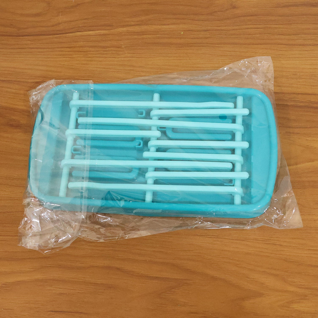 Side view of baby feeding bottle drying rack on kitchen countertop