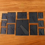 Premium matte black plastic photo frames arranged in a 12-piece set