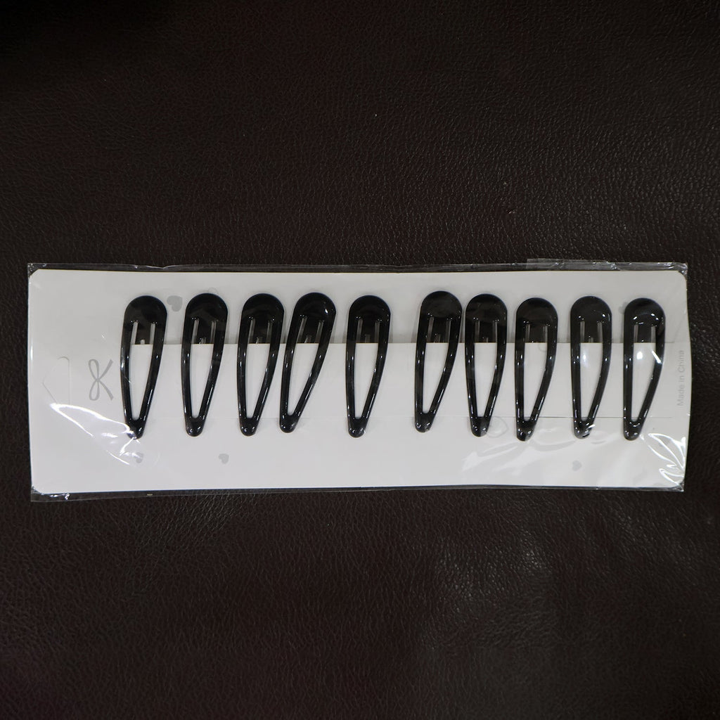 Matte finish metal hair clips held for size reference