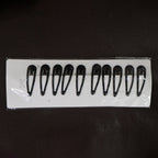Matte finish metal hair clips held for size reference