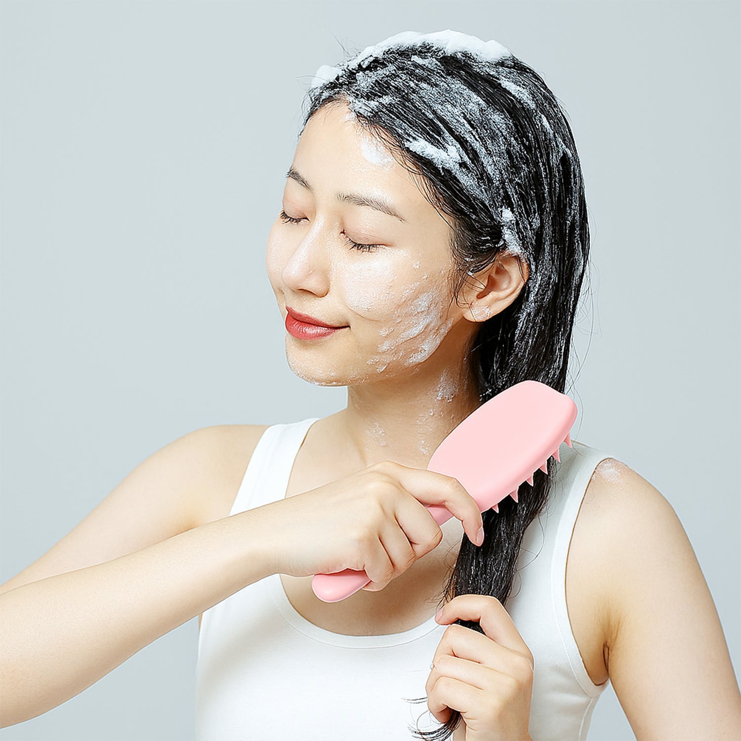 Unused silicone scalp massager brush showing soft bristles