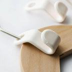White hanger connector hooks in use, creating a space-saving cascade in a wardrobe.