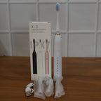 Electric toothbrush laid out with replacement brush heads for oral care