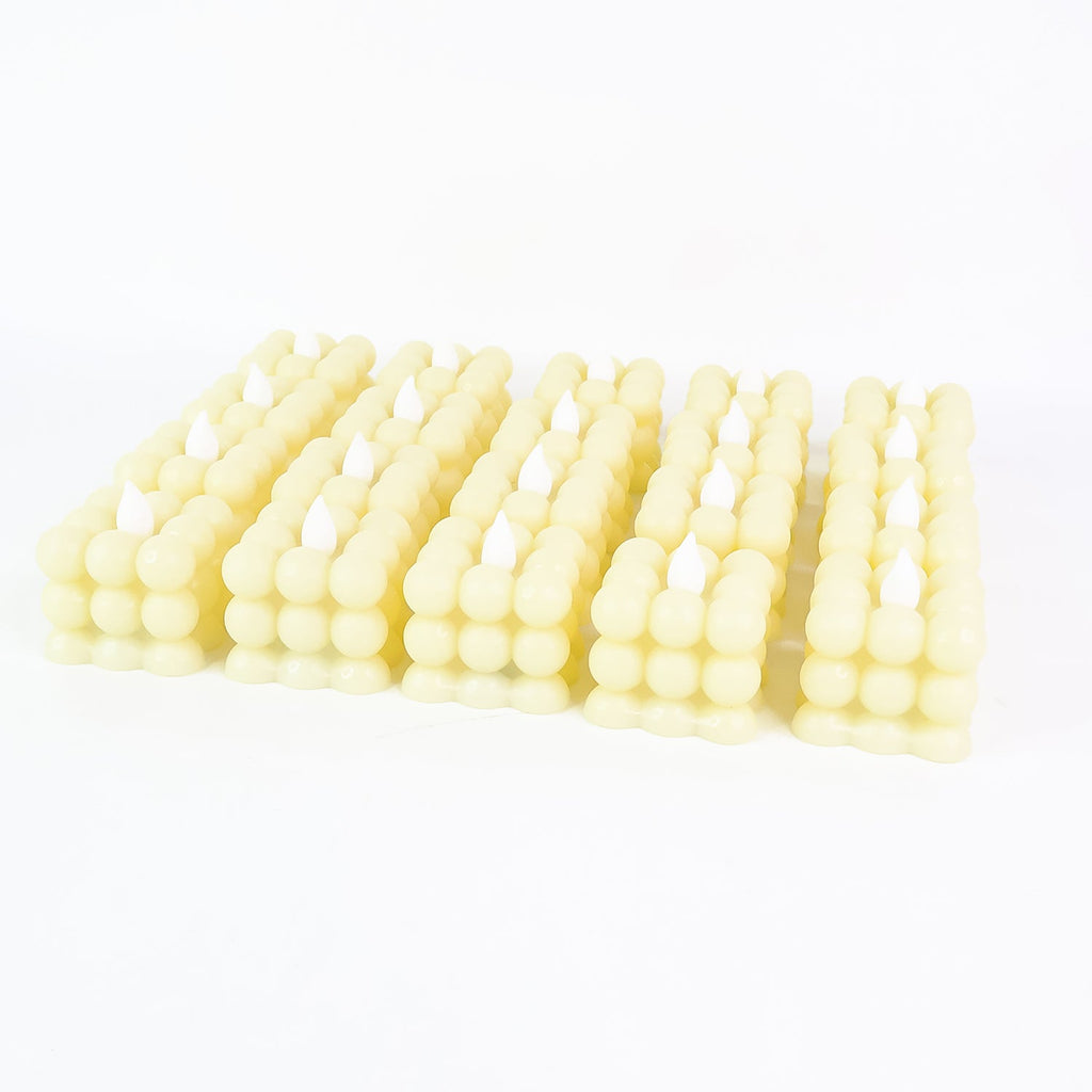 Decorative table setting illuminated by warm LED flameless cube candles