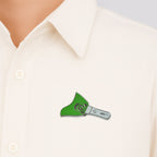 Close-up of metal badge pin attached on fabric showcasing enamel detail
