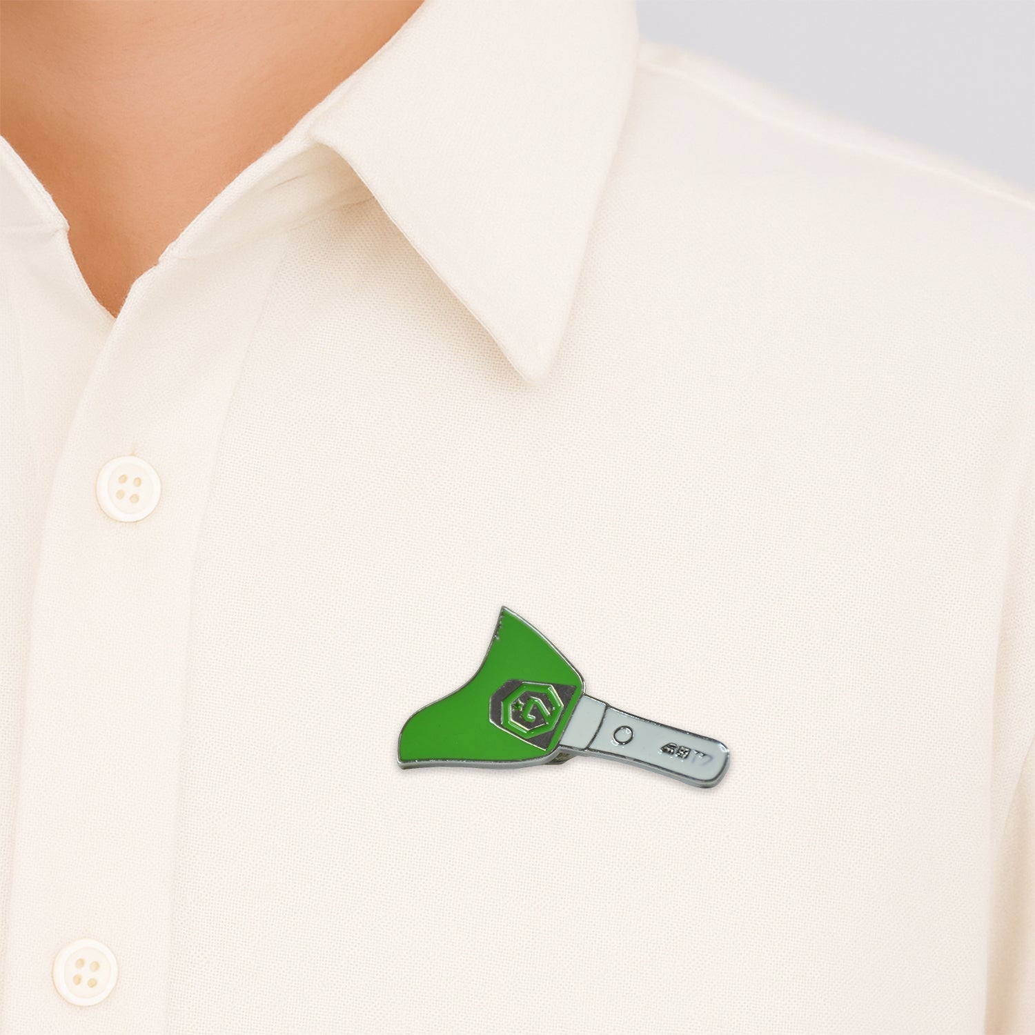 Close-up of metal badge pin attached on fabric showcasing enamel detail