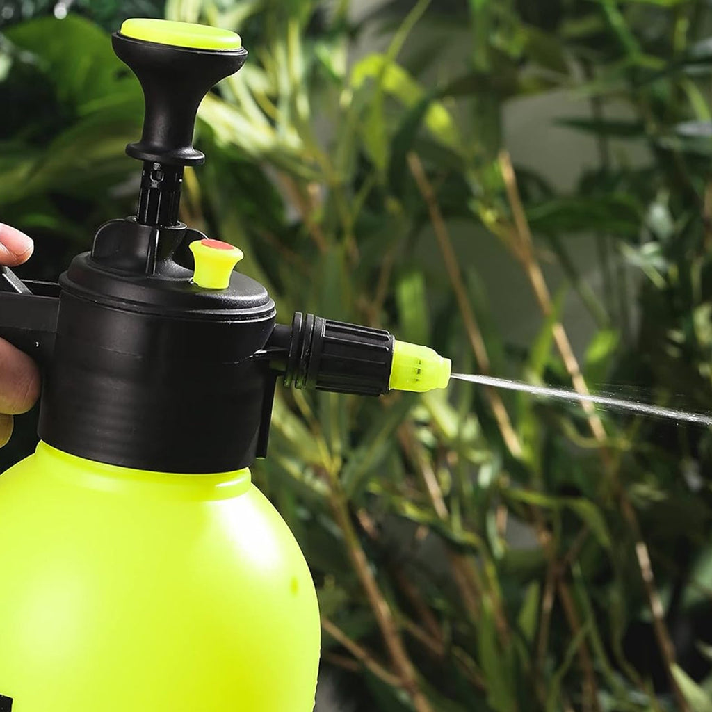 Hand holding the adjustable watering can spray nozzle, ready for use.