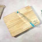 Knife blade detail resting on wooden cutting board