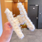 Plush hair claw clip securing a full head of hair, showing its strong yet gentle grip.