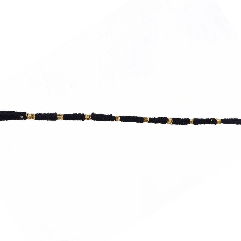Red Mauli rakhi with gold and pearl details for festival