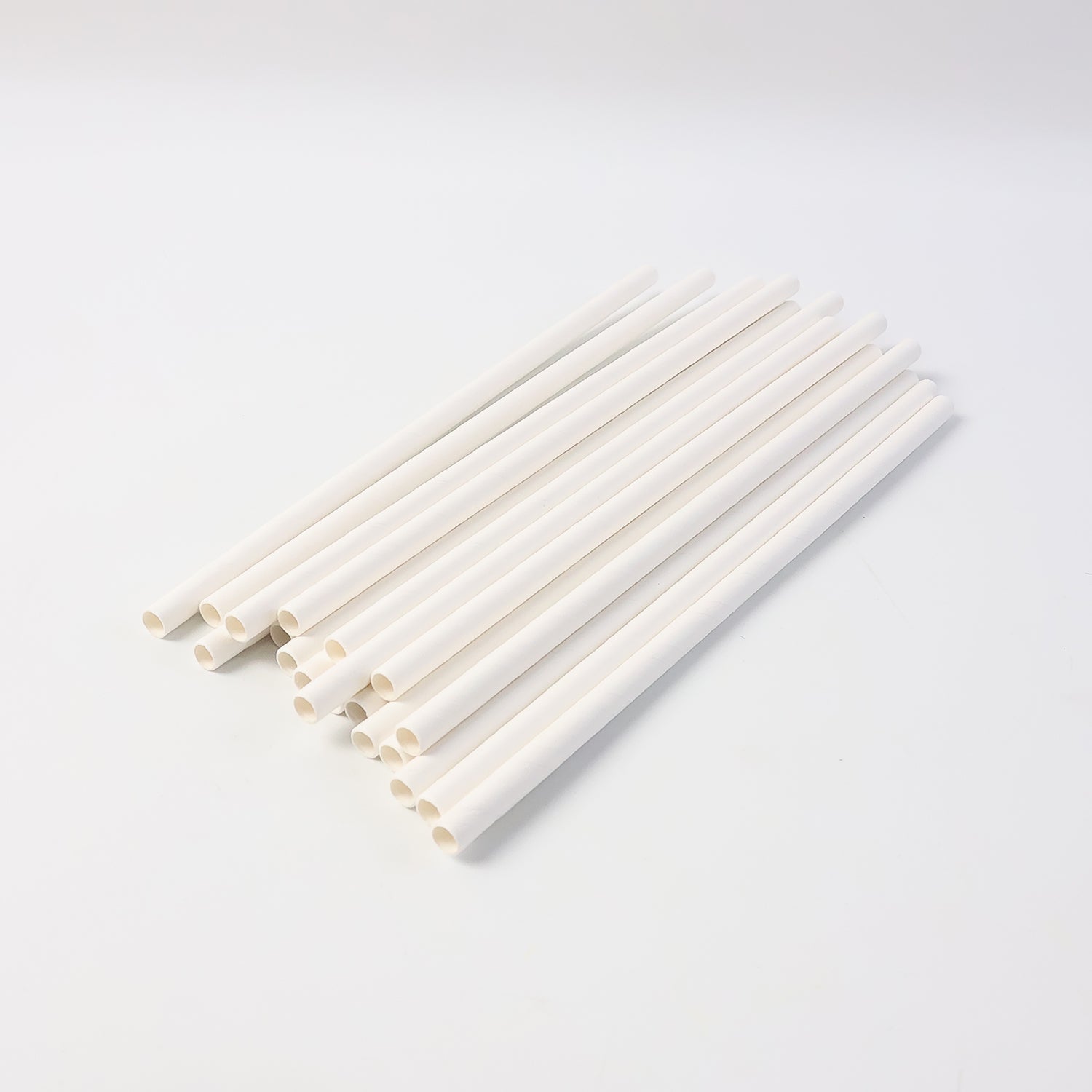 Eco-friendly paper straws displayed with green leaf, highlighting sustainable use