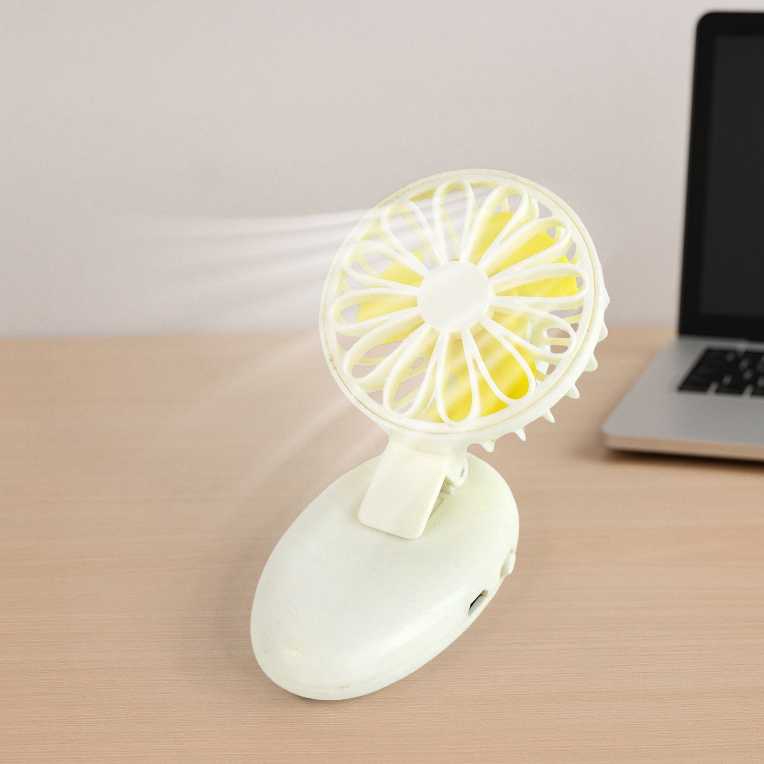Mini USB fan with its handle extended, ready for handheld use.