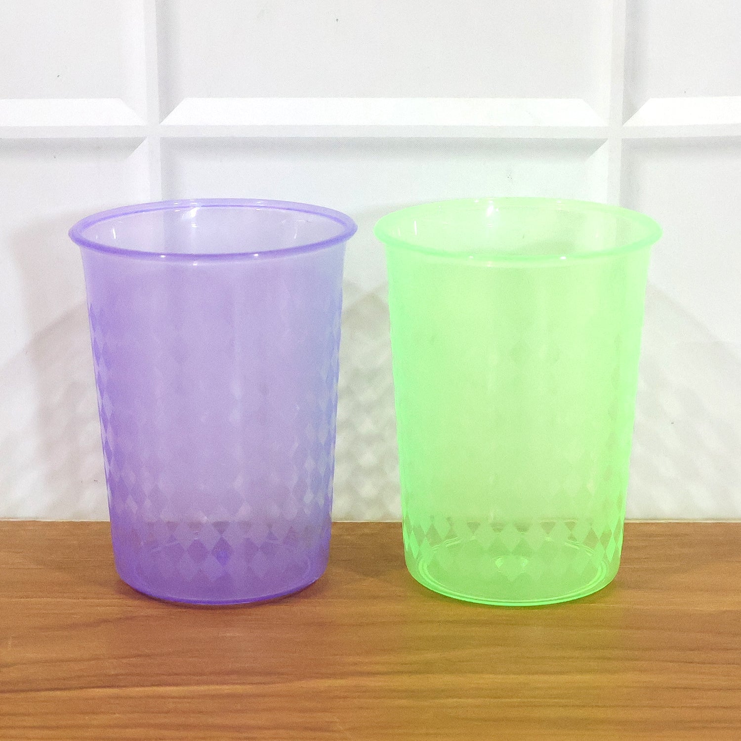 Stacked set of reusable plastic drinking glasses 200 ML in mixed vibrant colors