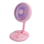 The portable fan with its LED light illuminated, perfect for camping or night use.