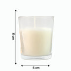 The Sweet Dreams Scented Votive Candle creating a serene ambiance on a bedside table.