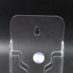 Durable ABS mobile holder securely displaying a phone on a bedroom wall.